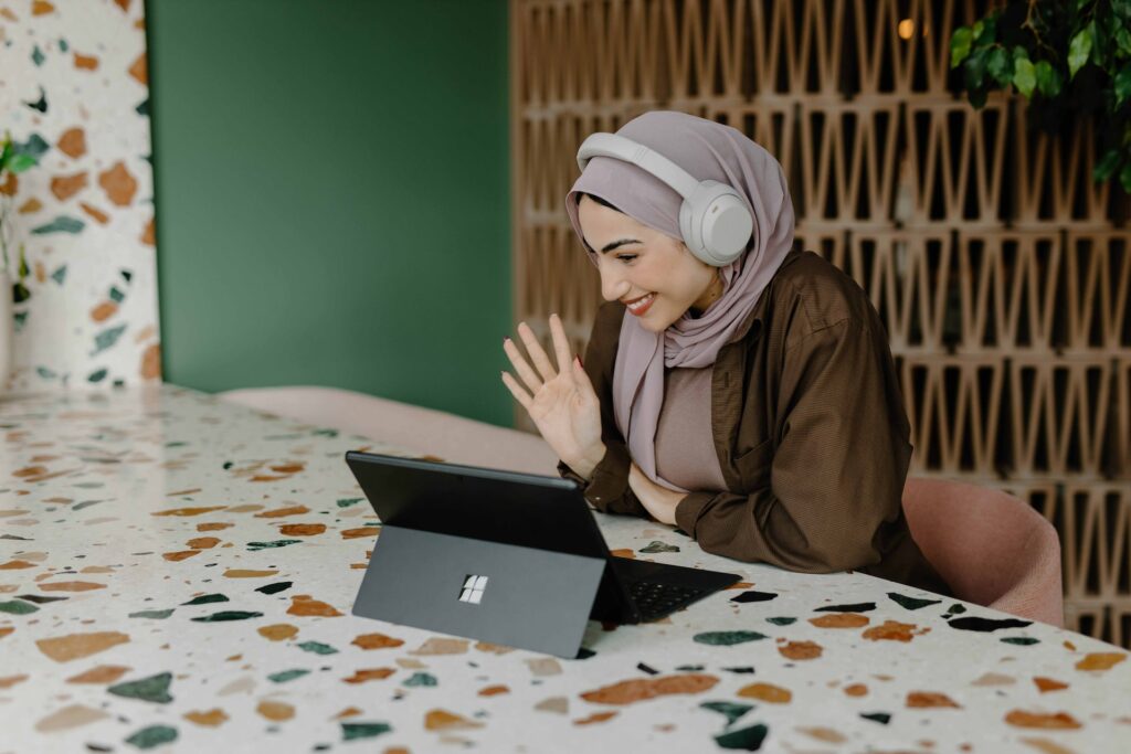 Woman participating in 10 not lame virtual team building activities.